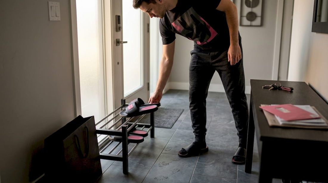 Man placing luxury slides in home entryway